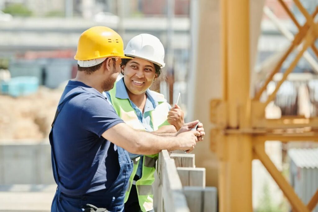 male and female construction workers collaborating