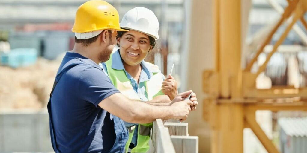 male and female construction workers collaborating